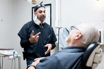 Dentist consulting with a patient at Happy Tooth